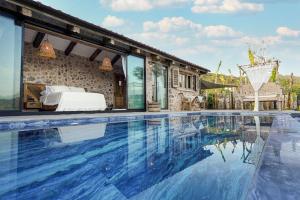 a villa with a swimming pool and a bed at Ada Dreams History - Adults Only in Fethiye