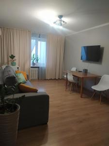 a living room with a couch and a table at Hotel Trias in Kyiv