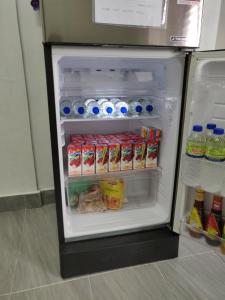 an open refrigerator filled with food and drinks at Raudah Homestay Kuala Nerang in Kuala Nerang