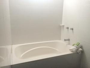 a bath tub in a bathroom with a towel on it at Hotel Bucaramanga Plaza in Bucaramanga +51 photos