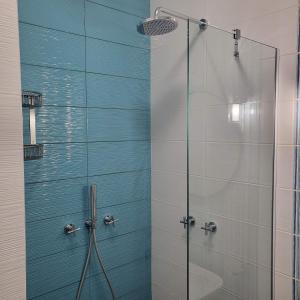 a shower with a glass door in a bathroom at New luxury apartment next to subway with garage in Sofia +29 photos
