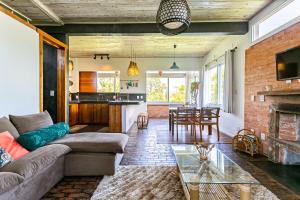 a living room with a couch and a fireplace at Stupa Eco Vila in Barra de Ibiraquera