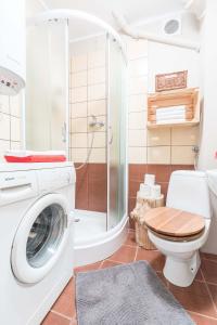 ein Bad mit einer Waschmaschine und einer Dusche in der Unterkunft Apartament Tosia Zakopane in Zakopane
