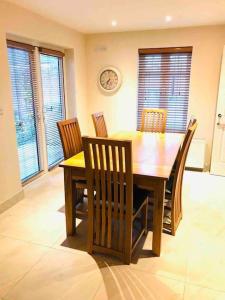 a dining room with a wooden table and chairs at Semi-detached Armagh House in Armagh +7 photos