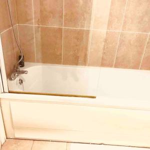 a bathroom with a tub and a shower with a shower at Semi-detached Armagh House in Armagh