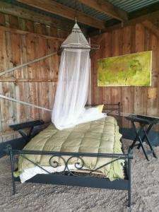a bedroom with a bed with a canopy at Lavendelmond Glamping in Barntrup