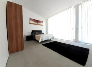 una camera con un letto e una grande finestra di Melrouse Place House a Pontevedra