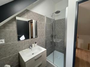 a bathroom with a sink and a shower at L’Éterle, maison de montagne in Aucun +28 photos