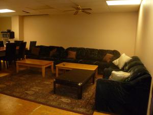a living room with a couch and a table at Vernon Hostel in Vernon