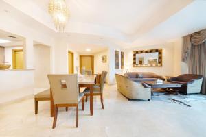 a living room with a table and a couch at Maison Privee - Spacious Apt with Beach, Pool and Marina Access in Dubai