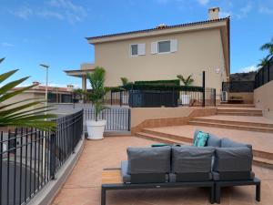 a patio with a couch in front of a house at Villa View Candesol con Jacuzzi privado in Puerto de Santiago