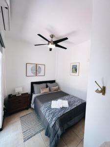 a bedroom with a bed and a ceiling fan at 3-BR in the heart of the Historical City in San Juan +14 photos