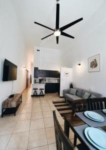 a living room with a couch and a ceiling fan at 3-BR in the heart of the Historical City in San Juan