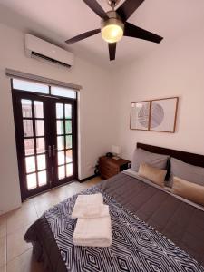 a bedroom with a large bed with a ceiling fan at 3-BR in the heart of the Historical City in San Juan