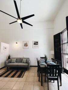 a living room with a couch and a ceiling fan at 3-BR in the heart of the Historical City in San Juan