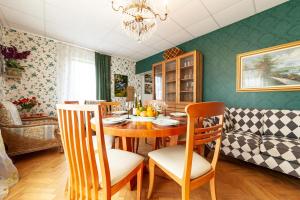 a dining room with a table and chairs at Old villa Kaprice Baltic Beach in Jūrmala