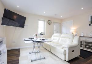 a living room with a white couch and a table at Canal View Cottage 