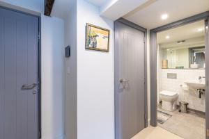 a bathroom with a door leading to a toilet at Carriage Works by Guestz in Preston +62 photos