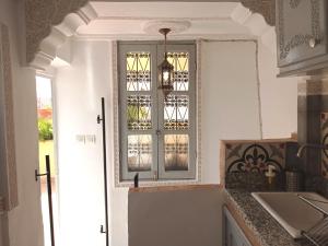 une cuisine avec une fenêtre et un comptoir dans l'établissement Dar Azahara, à Fès