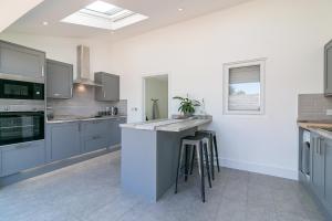 a kitchen with gray cabinets and a counter top at Archers Lodge in Stevenage