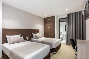 Voodi või voodid majutusasutuse Hotel Elite toas