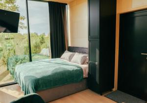 a bedroom with a bed and a large window at Juniper Villas I 
