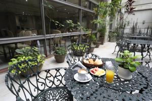 a table with food and drinks on a balcony at HR Esmeralda Luxor in Buenos Aires