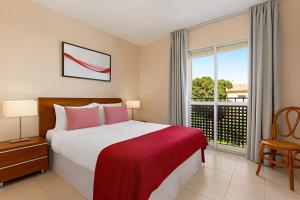 a bedroom with a bed and a large window at Ramada Hotel & Suites by Wyndham Costa del Sol in Fuengirola