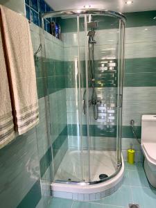 a glass shower in a bathroom with a toilet at Νέα μεσσαγγαλα luxury suite by MAKHOME no 2 in Nea Mesangala