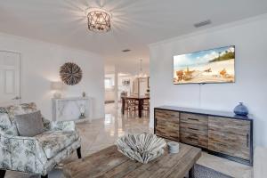 a living room with a couch and a table at Pool Home Super Close To Vanderbilt Beach in Naples