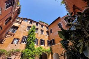 an old building with a tree in front of it at La Dimora Pantheon in Rome