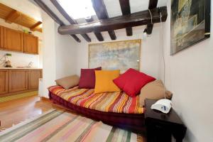 a couch with colorful pillows in a living room at La Dimora Pantheon in Rome