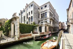 a couple of gondolas in a canal next to buildings at DOGE STAIR, gorgeous in Venice