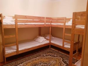 a room with three bunk beds in a room at Hostel 888 in Almaty