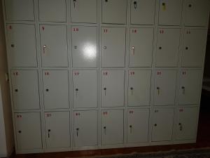 a wall of lockers with red numbers on them at Hostel 888 ALMATY in Almaty