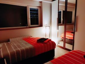 a bedroom with a bed and a large screen tv at La Ola de Cantabria in Miengo