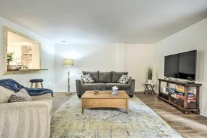 a living room with a couch and a tv at Walk to Dtwn and Breweries Townhome in Cary! in Cary