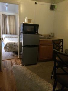 a kitchen with a microwave on top of a refrigerator at Lodge at Kennebunk in Kennebunk