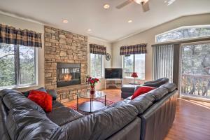 a living room with a leather couch and a fireplace at Secluded Prescott Home Less Than 2 Mi to Whiskey Row! in Prescott