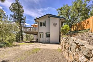 a house with a balcony and a stone wall at Secluded Prescott Home Less Than 2 Mi to Whiskey Row! in Prescott