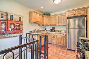 a kitchen with wooden cabinets and a stainless steel refrigerator at Secluded Prescott Home Less Than 2 Mi to Whiskey Row! in Prescott