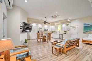 a living room with a couch and a table at Sunny Kailua Home with Covered Lanai 1 Mi to Beach! in Kailua