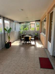 an empty patio with a table and chairs and windows at Šmek in Belgrade