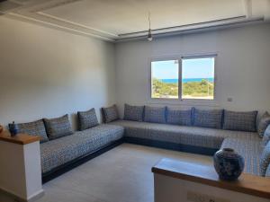 a waiting room with a couch and a window at Superbe appartement avec vue sur mer in Saïdia