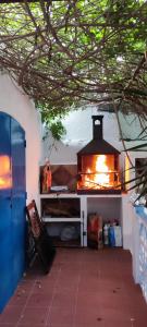 a kitchen with an oven with a fire in it at Casa Rural La Fuensanta in Mojácar