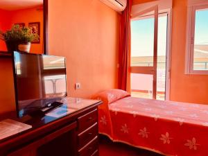 Posteľ alebo postele v izbe v ubytovaní Hostal Muriel