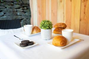 a table with two plates of bread and two cups of coffee at Le Rotche III in La Roche-en-Ardenne +11 photos