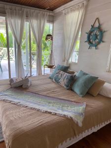 a large bed in a room with a window at Islander House on Rocky Cay Beach in San Andrés