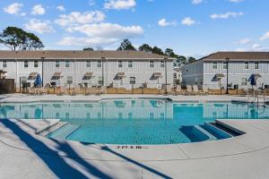a swimming pool in front of a building at LUXURY TOWNHOME NEAR DOWNTOWN AND PENSACOLA BEACH in Pensacola