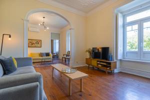 un soggiorno con divano e TV di Saldanha Charming Palace a Lisbona